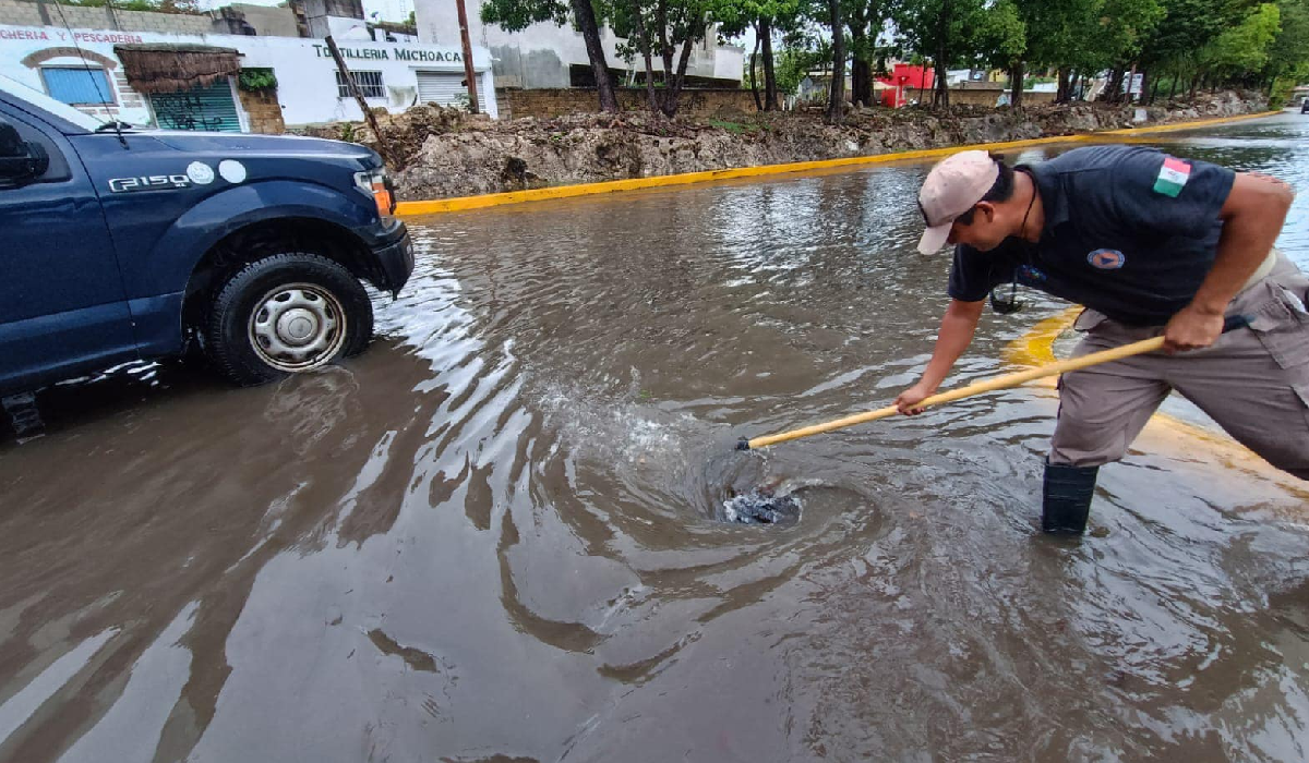 Trabajadores realizan limpieza de alcantarillas en Cancún tras lluvias.