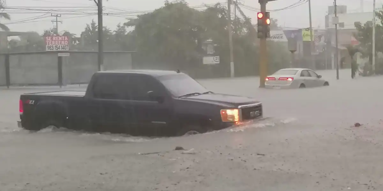 calles inundadas con vehículos semi sumergidos