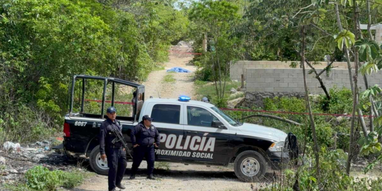 Policía municipal junto al cuerpo encontrado en colonia El Mariachi
