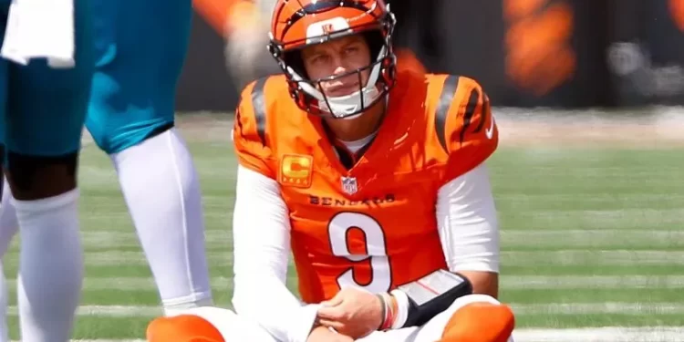 Joe Burrow sentado en el campo tras sufrir una lesión con los Bengals
