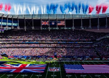 Vista panorámica del estadio de Londres durante un juego internacional de la NFL, con banderas de Reino Unido y Estados Unidos sobre el campo.